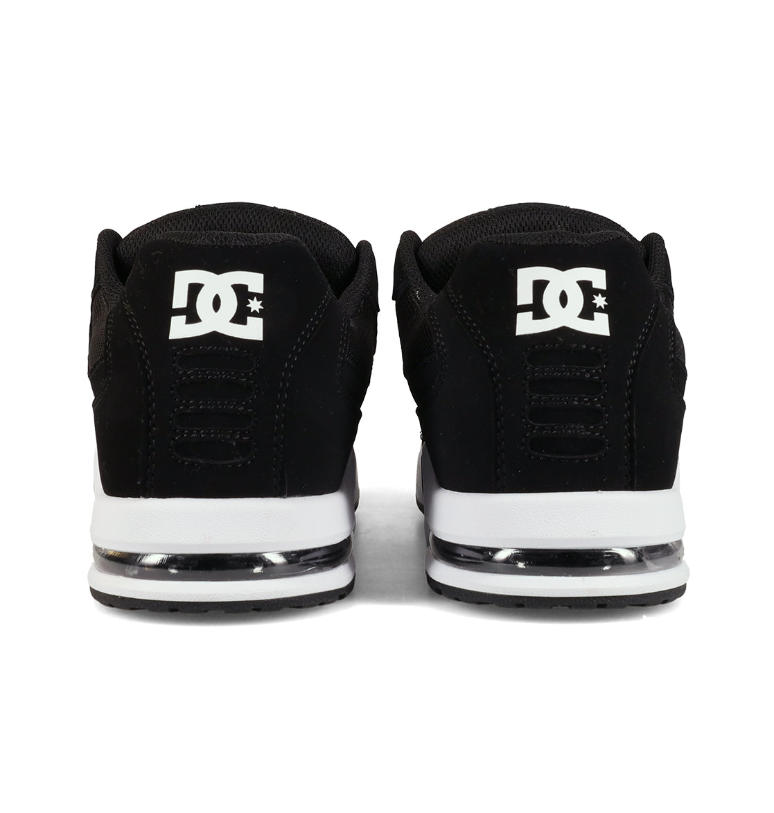 A pair of black Men’s AT-2 Shoes by DC Shoes viewed from the back, showcasing the signature white DC logo on the heel and white midsoles with a translucent accent above the outsole. Engineered for breathable comfort, these skate shoes keep your feet cool and supported throughout every session.
