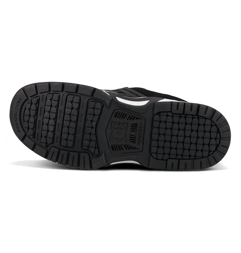 The bottom view of the Men’s AT-2 Shoes by DC Shoes showcases a black outsole with textured tread patterns, featuring the DC Shoes logo at the center and RESIST+COLOR text on the heel. Visible grooves provide grip for cushioned impact and enhanced support, while integrated AEROTECH ventilation channels offer breathable comfort—all set against a white background.