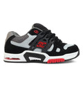 The Men’s AT-2 Shoes by DC Shoes feature a black, grey, and white design with bold red accents. They showcase the DC logo, a chunky lacing system, and a supportive TPU cage for enhanced stability. The midsole includes the AEROTECH ventilation system for breathability, while cushioned impact comfort and a red outsole provide superior grip.