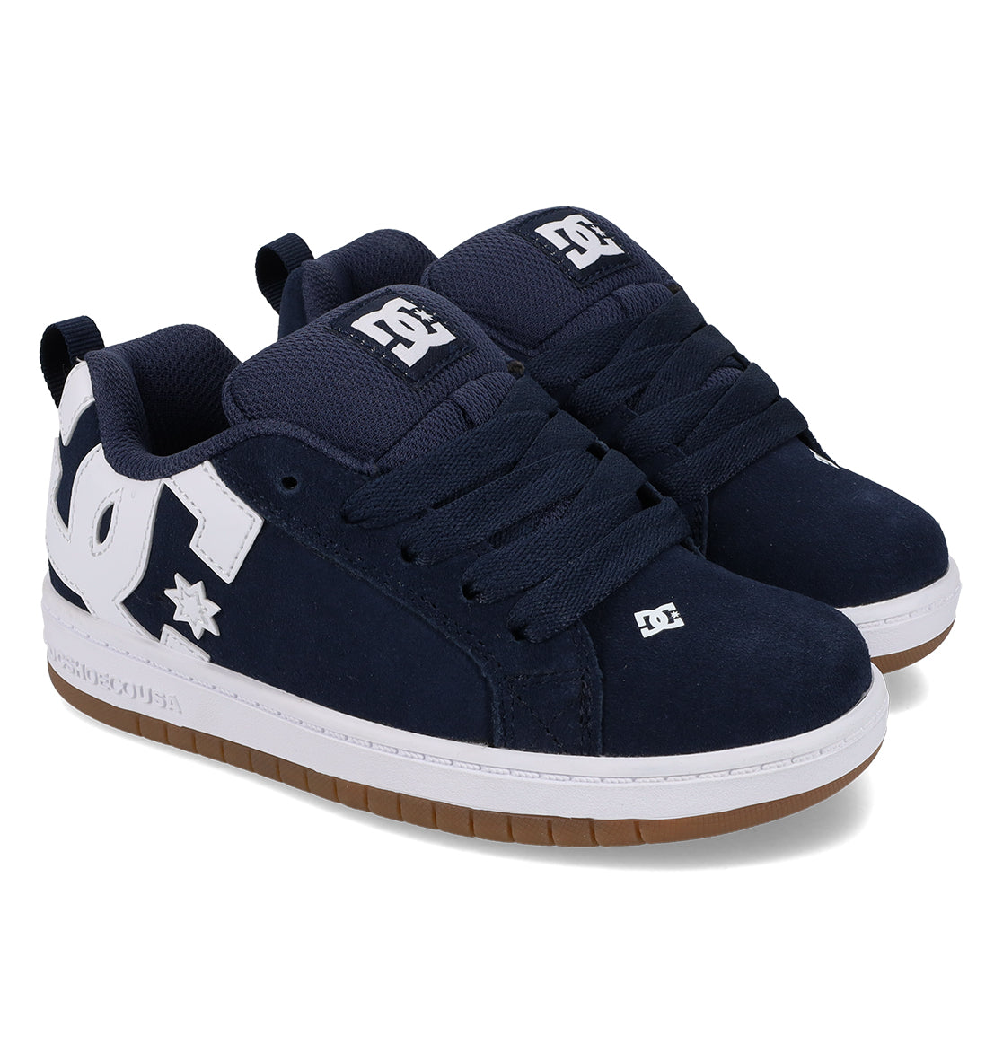 A pair of DC Shoes Kids’ Court Graffik skate shoes in navy blue, featuring a puffy silhouette, thick white logos, chunky laces, and brown rubber soles, displayed on a white background.