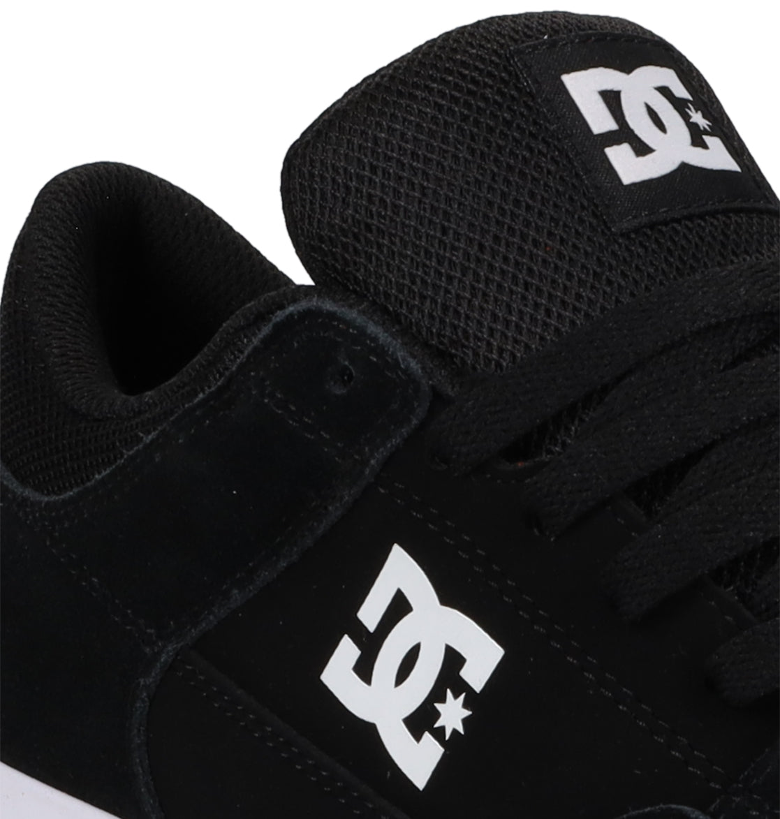 Close-up of the Men’s Onyx Shoes by DC Shoes in black, showcasing a white DC logo on the side and tongue, black laces, and mesh detailing on the tongue. The minimal silhouette makes these skate shoes an everyday go-to for both style and comfort.