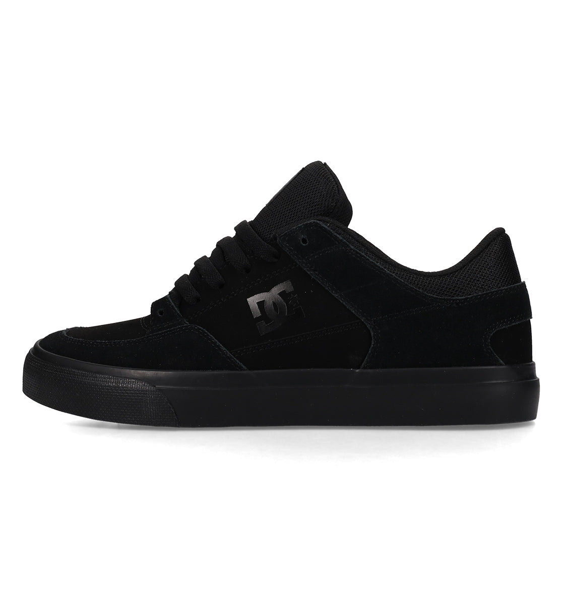 A black low-top skate shoe with a suede and mesh upper, black laces, a rubber sole, and the DC Shoes logo on the side.