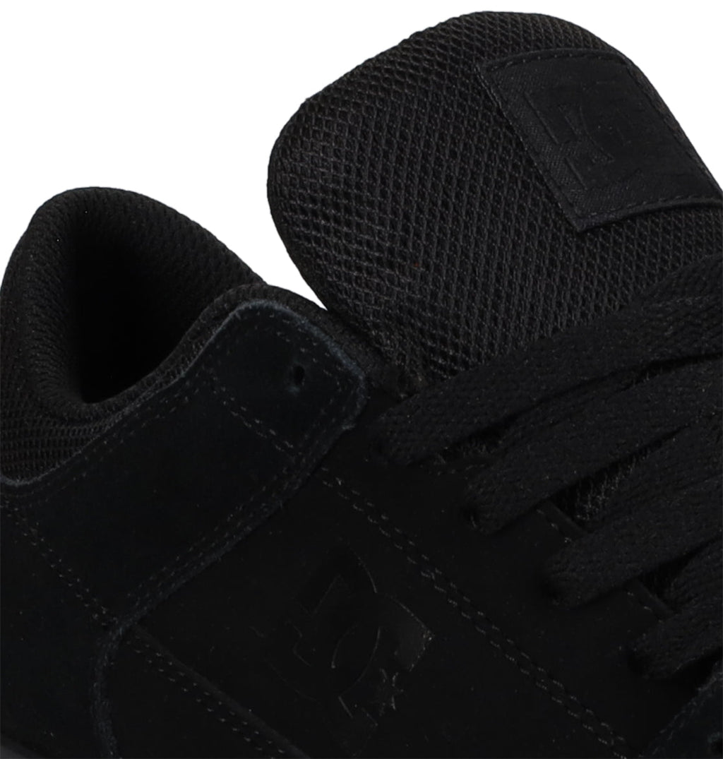 Close-up of the Men’s Onyx Shoes by DC Shoes, featuring a black sneaker design with black laces and mesh tongue, plus a subtle embossed DC logo on the side and tongue. This minimal silhouette makes it an everyday go-to vulc shoe for effortless style and comfort.