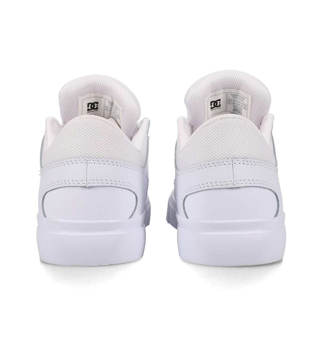 Back view of a pair of Men’s Onyx Shoes by DC Shoes in white, featuring mesh detailing around the ankle, visible DC branding on the tongue tags, and clean, flat soles—an everyday vulcanized shoe crafted for both comfort and style.