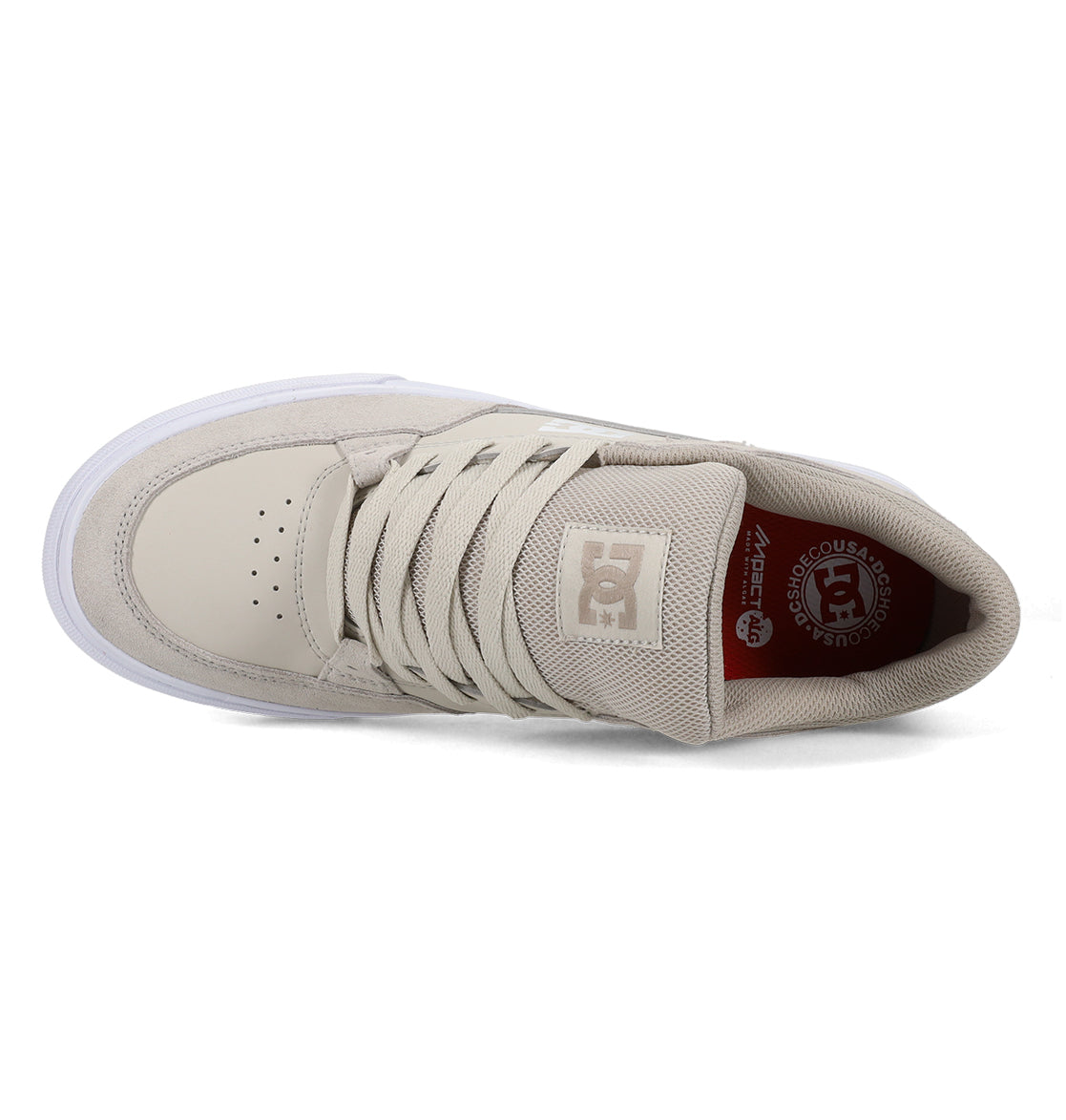 Men’s Onyx Skate Shoe by DC Shoes in beige, seen from above to highlight the laces, toe perforations, and DC logo on the tongue. Featuring a minimal silhouette with a white vulcanized sole, this everyday go-to shoe also reveals part of its interior label.