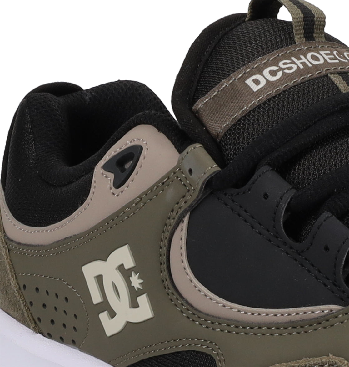 Close-up of the Men’s Kalynx Zero Shoes by DC Shoes, taking inspiration from the Lynx Zero and Kalis Lite silhouettes, showcasing black, olive green, and beige color blocks. The DC Shoes logo is prominently featured on the side with additional branding on the tongue.
