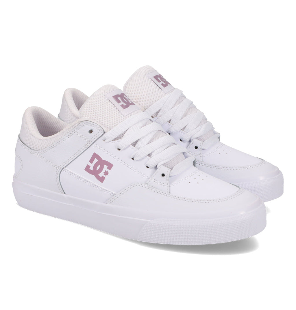 A pair of DC Shoes Women’s Onyx Shoes in white, featuring a minimal silhouette with light purple logos and accents, displayed at an angle on a white background—an everyday go-to vulc shoe that offers both style and comfort.