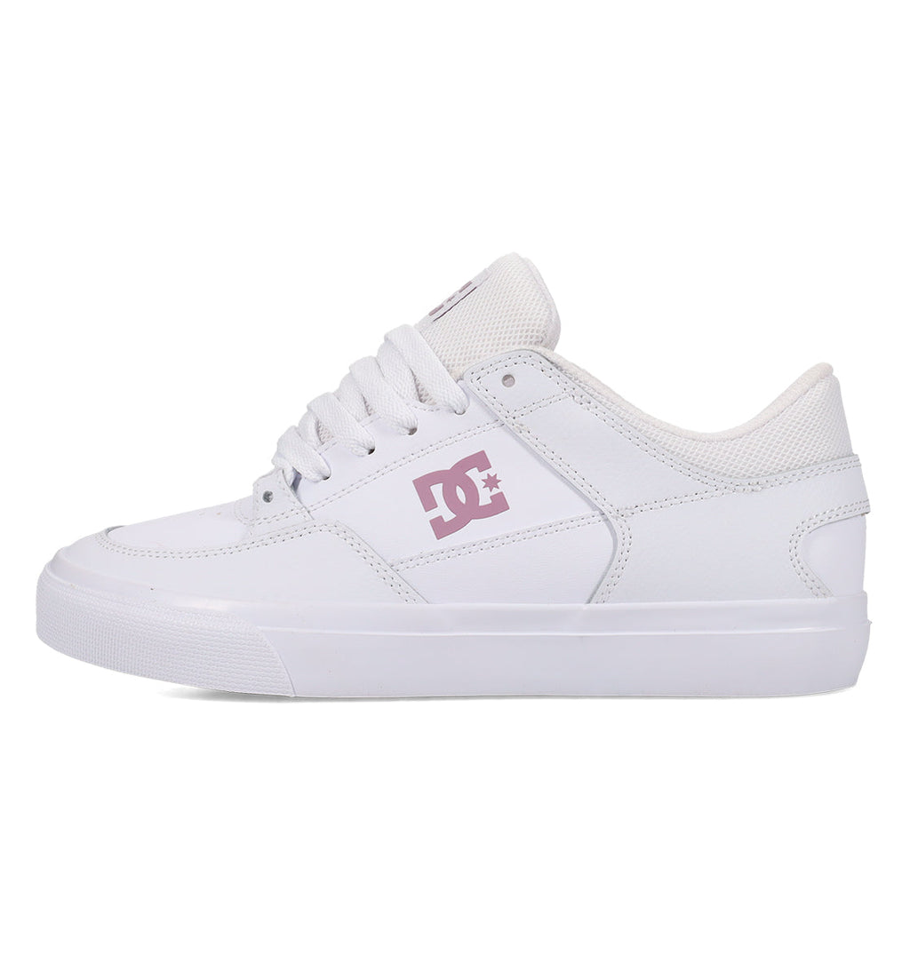 The Women’s Onyx Shoes by DC Shoes showcase a clean white vulcanized design with a subtle light pink DC logo on the side, matching white laces and sole, and a minimalist silhouette—captured in left side profile against a white background—making them an ideal everyday go-to.
