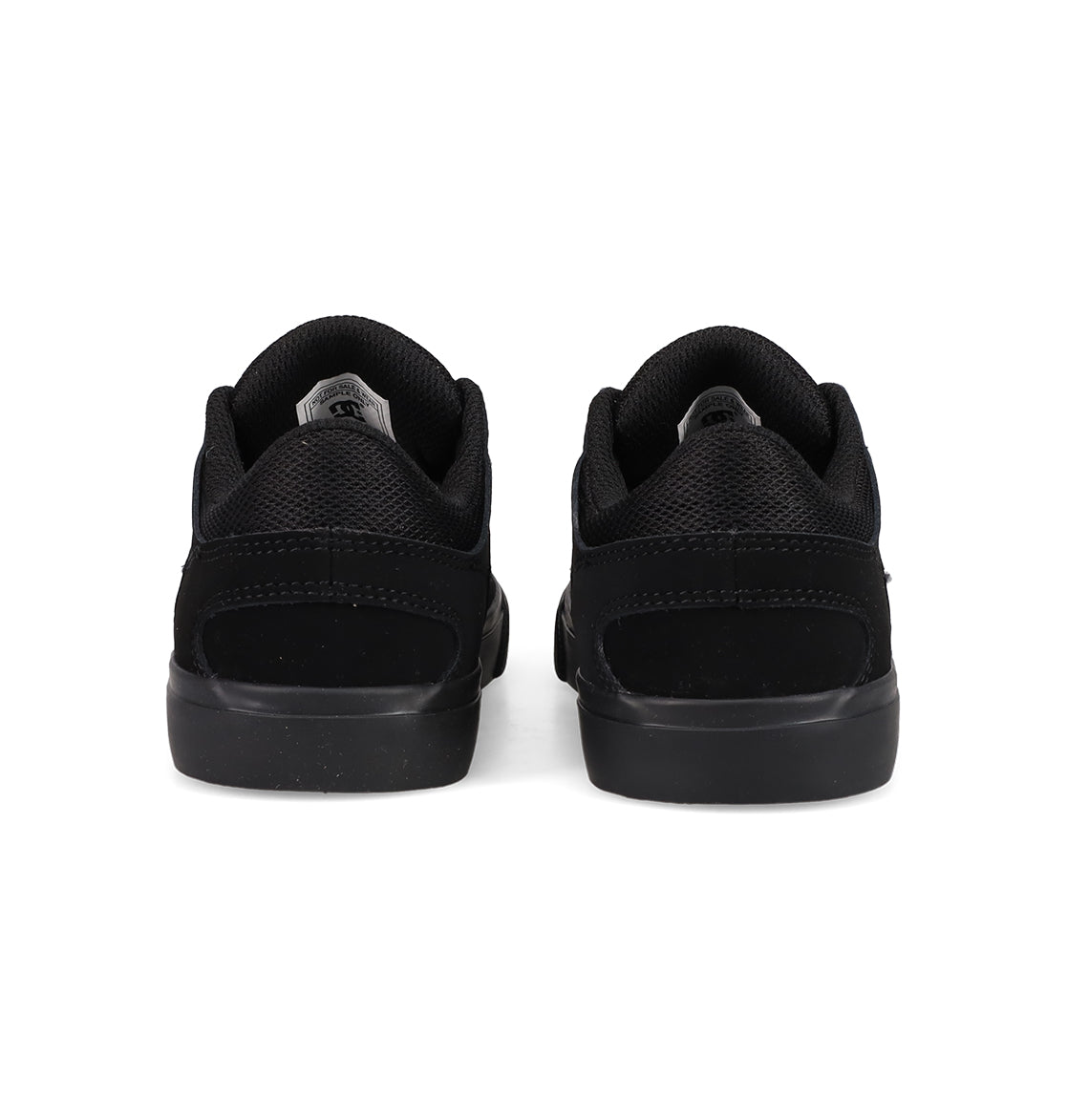 A pair of Kids' Onyx Shoes by DC Shoes, featuring a minimal black silhouette, are shown from the back side by side on a white background—perfect everyday sneakers.