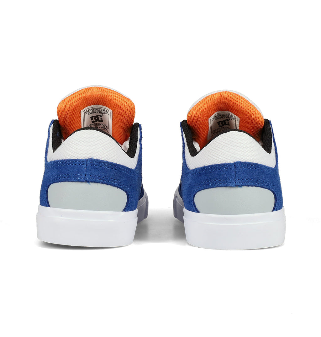 Pair of blue, white, and orange low-top Kids’ Onyx Shoes by DC Shoes shown from the back on a white background. The insides are orange, the heel area is blue with a light gray accent, and the shoes have white soles. Featuring a minimal silhouette, these vulc shoes are designed to be your everyday go-to for effortless style and comfort.