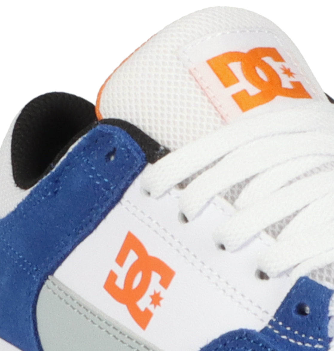 Close-up of the Kids’ Onyx Shoes by DC Shoes, showcasing blue suede, white laces, and an orange DC logo on the side and tongue. Designed with a minimal silhouette, this vulcanized shoe features a black lining and white mesh accents—making it a stylish everyday choice.