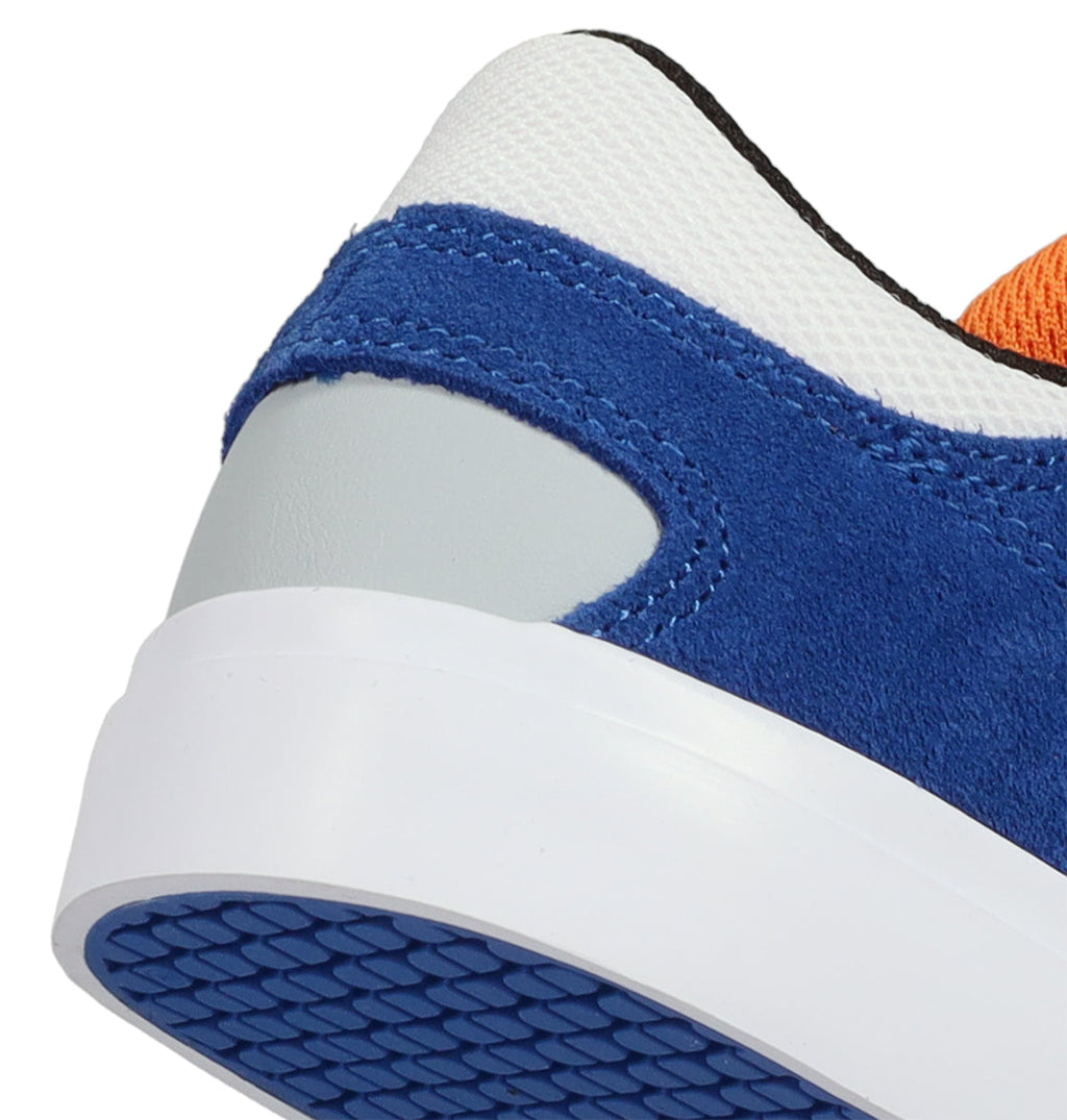 Close-up of the back heel of the Kids’ Onyx Shoes by DC Shoes, featuring blue suede, gray and white accents, an orange upper section, and a blue textured sole—designed with a minimal silhouette that makes them your everyday go-to sneakers.