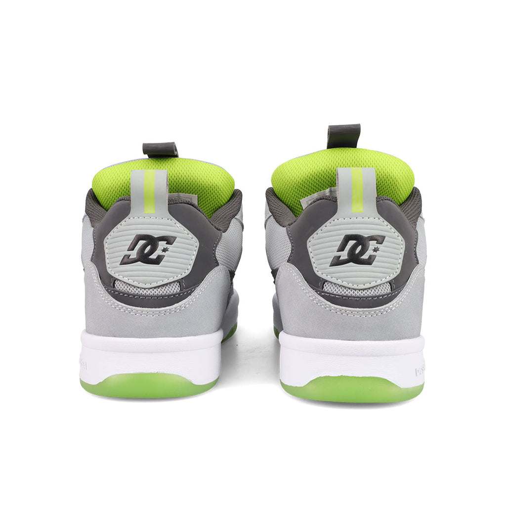 A pair of gray and white Men's JS 2 Shoes from DC Shoes seen from the back, with green inner lining, green and white soles, and the DC logo on the heel—reflecting DC Shoes heritage in every detail.