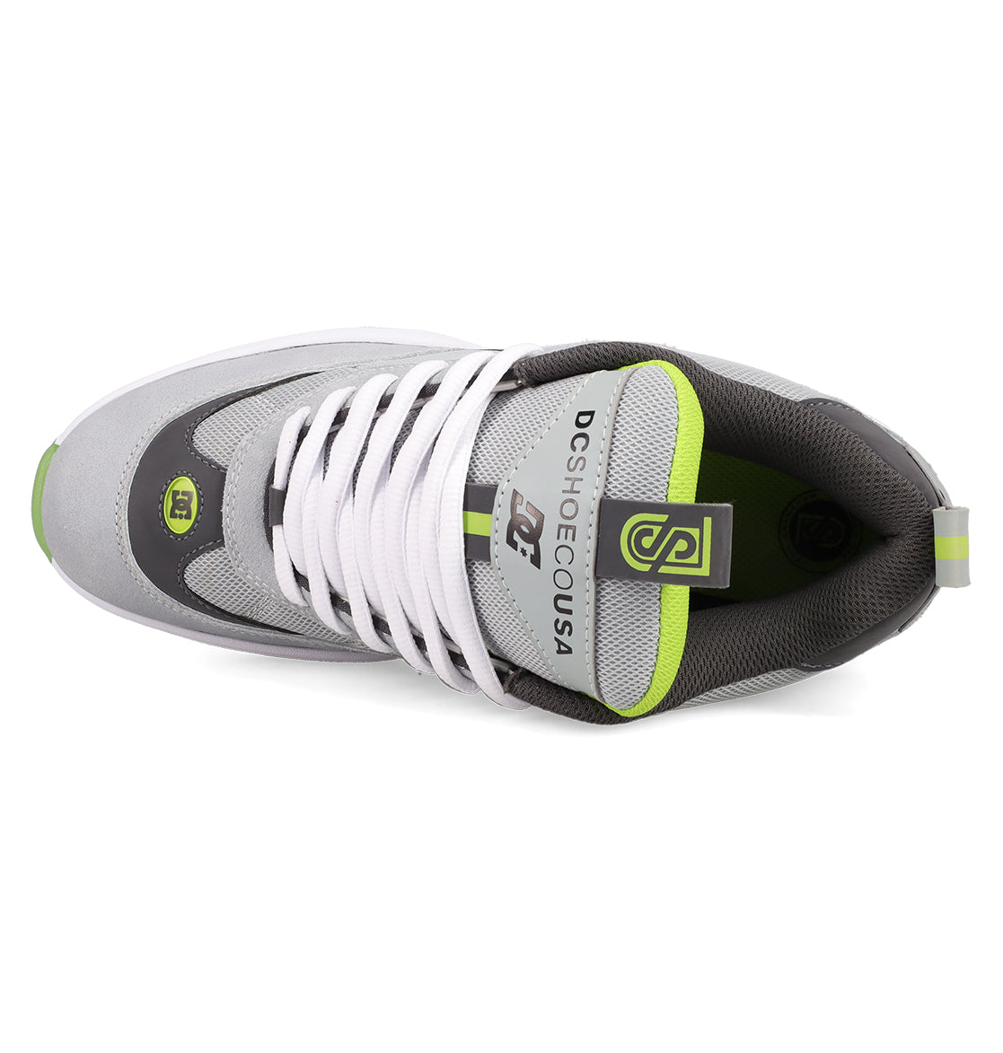 Top view of the Men's JS 2 Shoes by DC Shoes in gray and white with green accents, white laces, and DC SHOE CO USA branding on the tongue, showcasing heritage details inspired by John Shanahan's pro model.