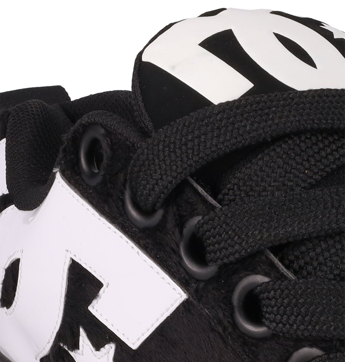 Close-up of DC Shoes Men's Court Graffik Puff Shoes in black, featuring thick laces, black eyelets, a bold white DC logo on the side and tongue, and an exaggerated puffy upper for standout style.