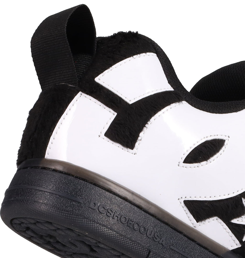 Close-up of the Men's Court Graffik Puff Shoes by DC Shoes, featuring a black sole, exaggerated black and white upper, fuzzy black heel, stitched details, and "DCSHOECOUSA" embossed near the heel.