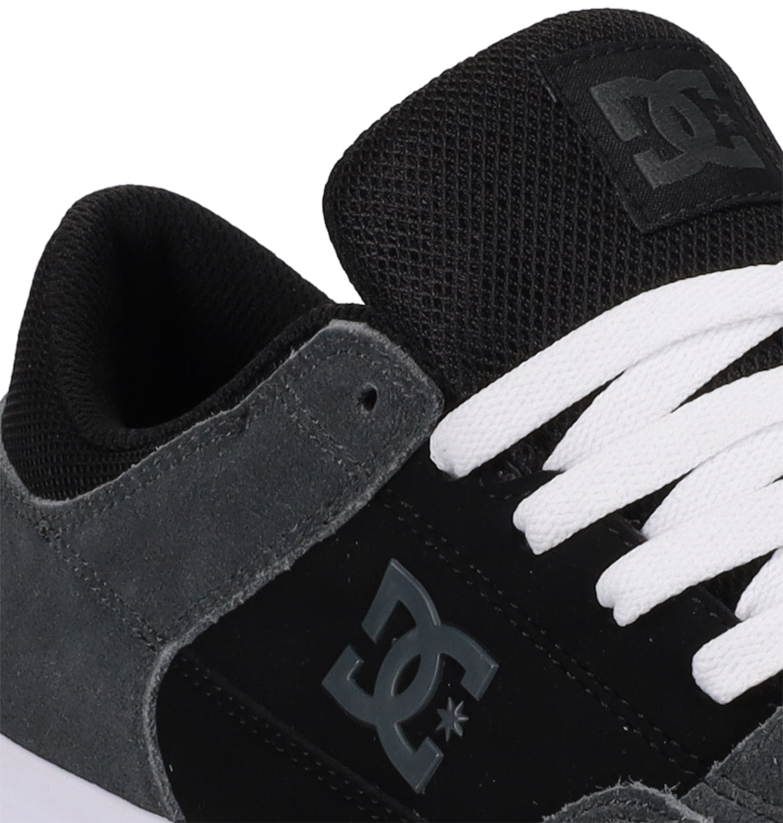 Close-up of the DC Shoes Men’s Onyx Skate Shoes in black and grey, featuring white laces, the signature DC Shoes logo on the side, and a combination of suede and mesh textures on the upper. The minimal silhouette highlights its vulcanized shoe design for a clean, modern look.