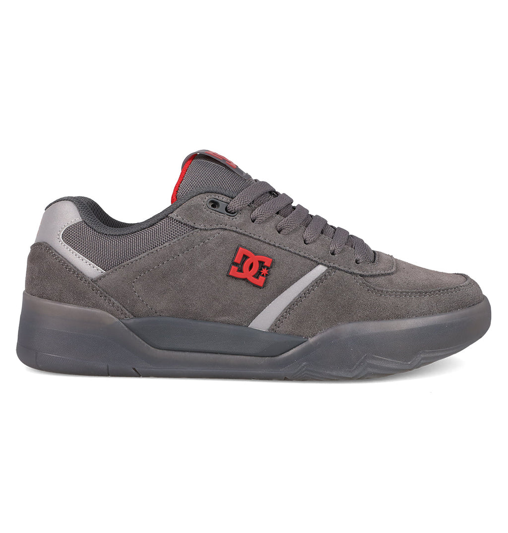 The Men's Fractal SE Shoes by DC Shoes feature a grey suede upper, thick sole, padded collar, grey laces, red DC logo, and black outsole—a low-top design blending street style with all-day performance comfort.