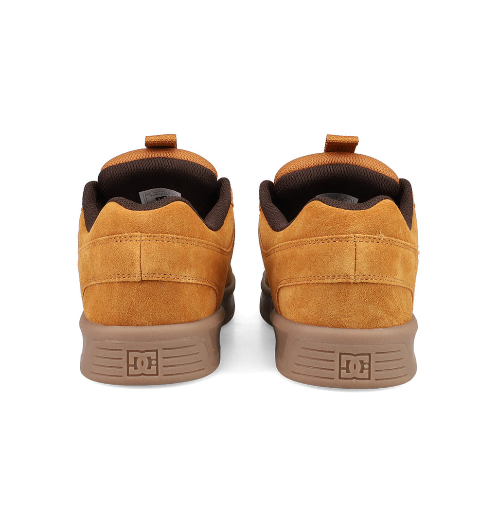 The Men's Lynx Zero SE Shoes by DC Shoes are brown skate shoes with suede uppers, DC-branded brown soles, and a matching brown inner lining, shown from the back.