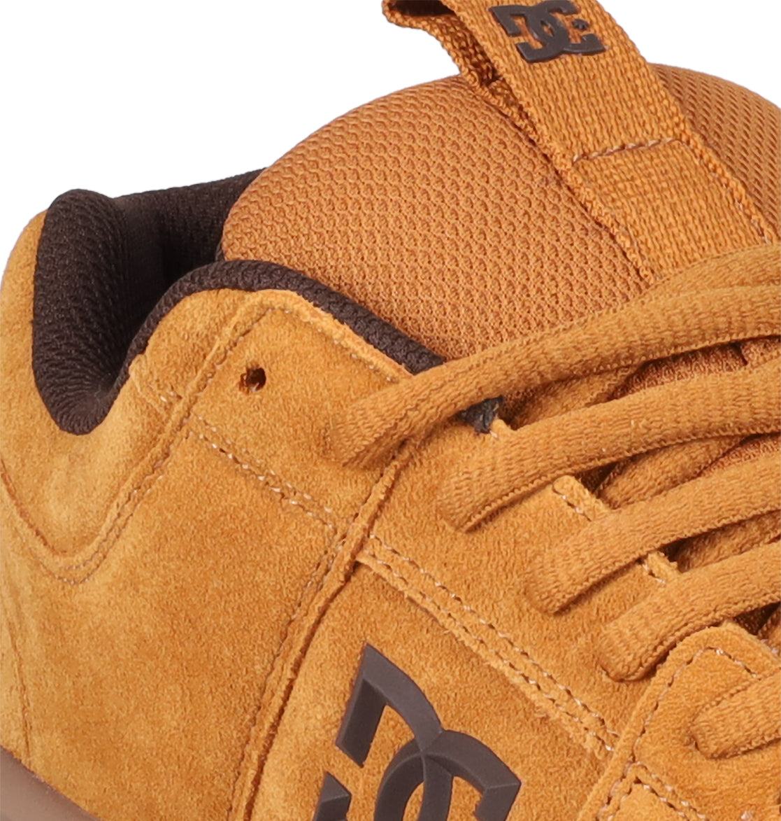 Close-up of the Men's Lynx Zero SE Shoes by DC Shoes in orange-brown suede, featuring matching laces, a side DC logo, and a textured tongue with an embossed DC emblem.