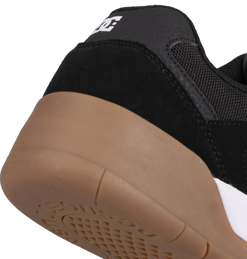 Close-up of the heel on the Men's Fractal S Shoes by DC Shoes, featuring a black upper, gum rubber sole, white DC logo, and detailed stitching—combining signature style with comfort built for performance.