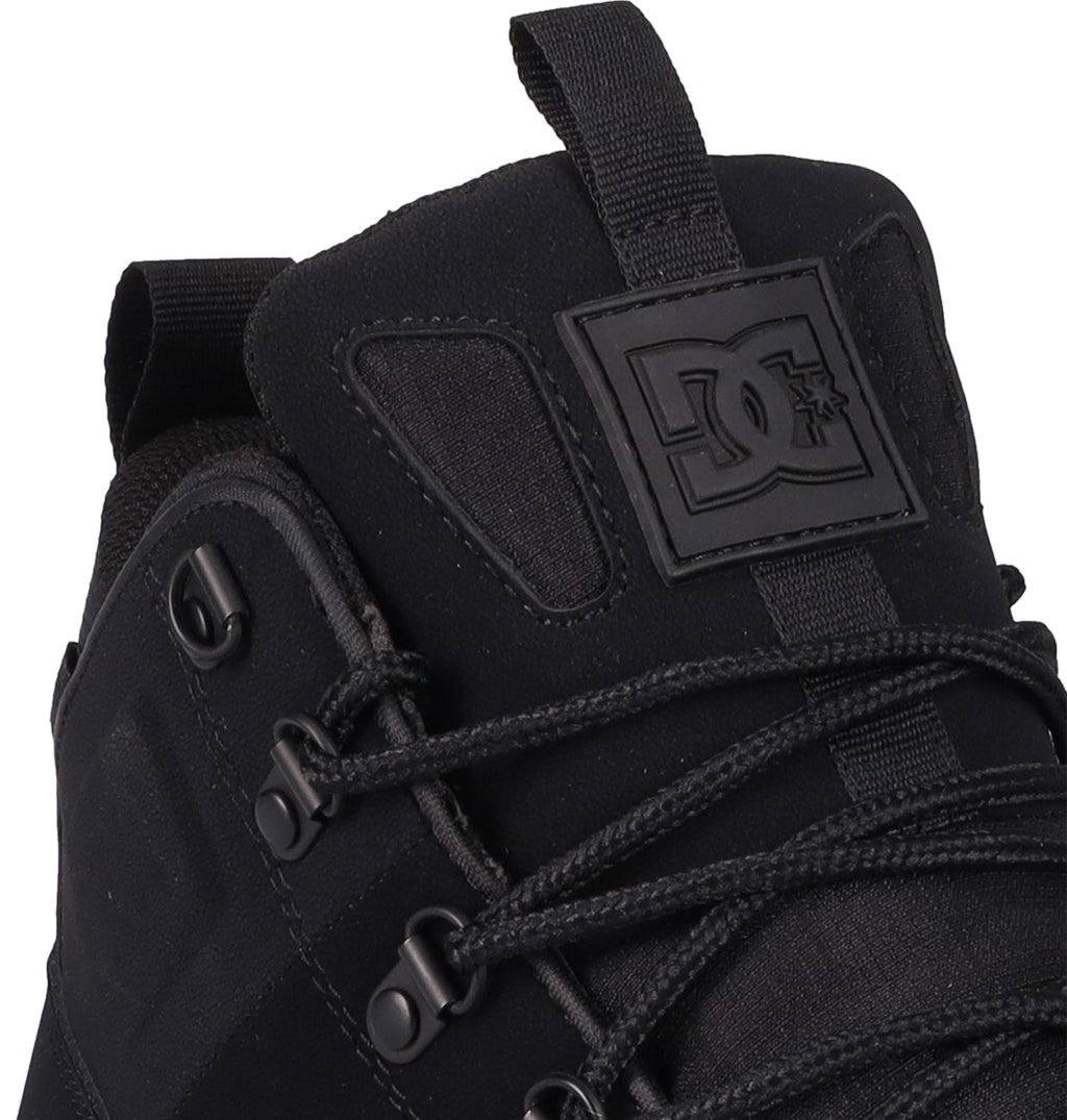 Close-up of the Men's DC Tarmont Shoes by DC Shoes, featuring black laces, metal eyelets, and a raised logo patch on the tongue. Crafted from a blend of leather and fabric for a street-ready look and all-day comfort.