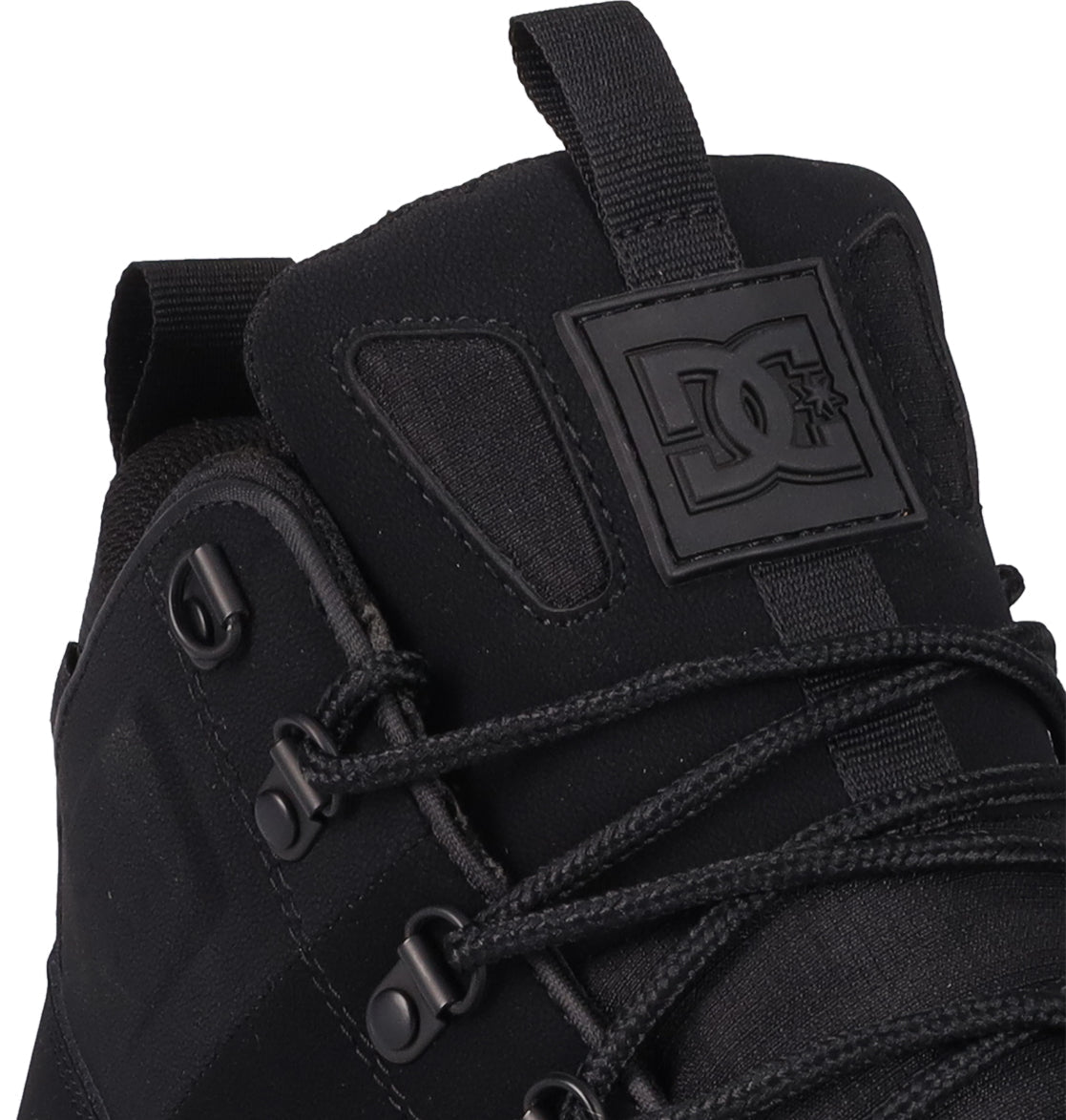 Close-up of the Men's DC Tarmont Shoes by DC Shoes, featuring black laces, metal eyelets, and a raised logo patch on the tongue. Crafted from a blend of leather and fabric for a street-ready look and all-day comfort.