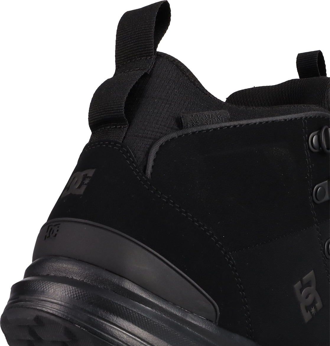 Close-up of the heel and side of the Men's DC Tarmont Shoes by DC Shoes, featuring a black pull tab, black sole, subtle branding, and a smooth suede or nubuck finish for a street-ready style inspired by outdoor boots.