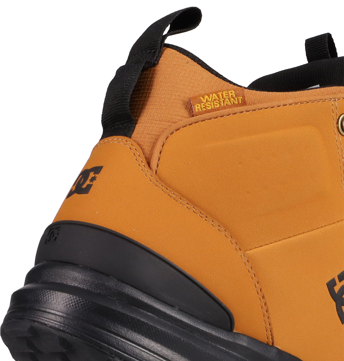 Close-up of the heel and ankle area of the Men's DC Tarmont Shoes by DC Shoes in tan and black. Features a WATER RESISTANT label, pull tab, black DC logo, and all-weather performance—ideal for edgy street style.