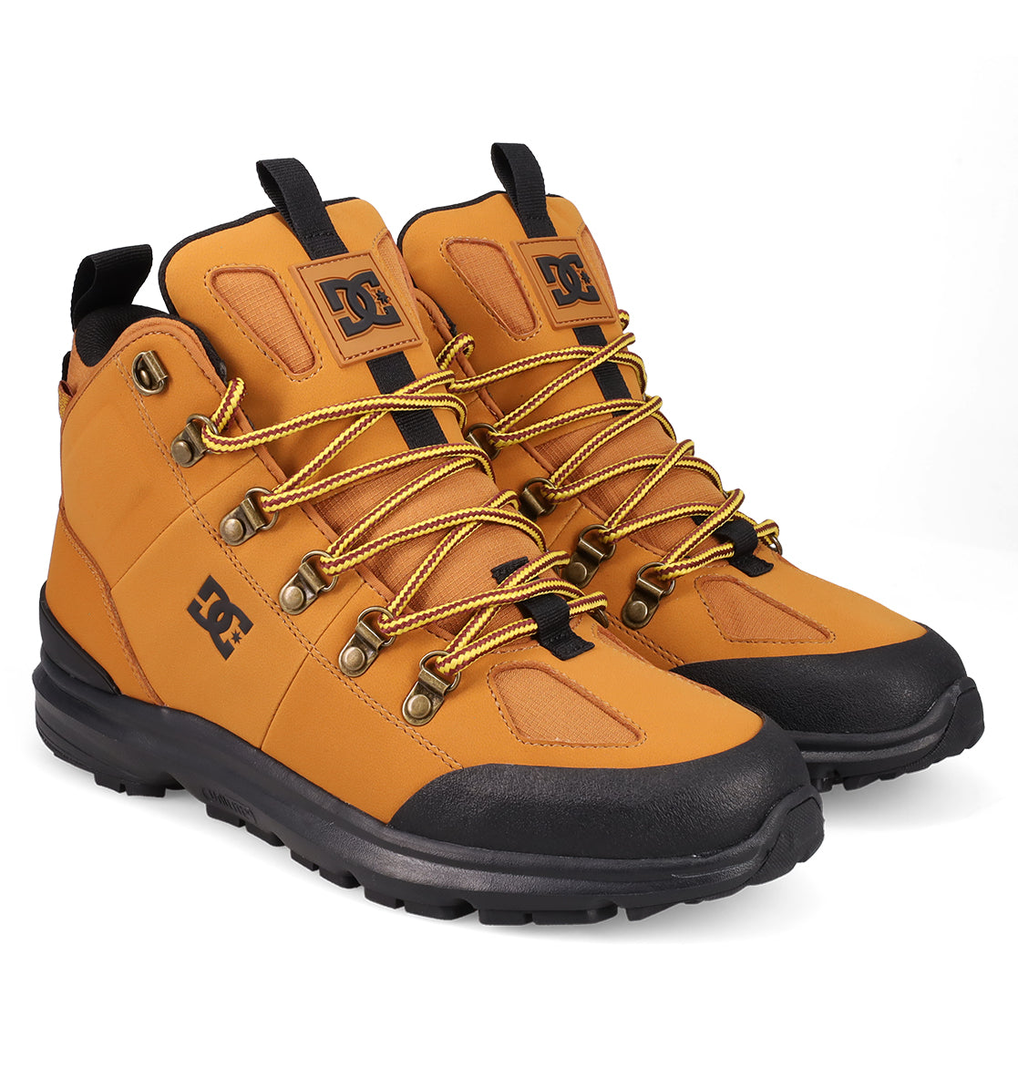 The Men's DC Tarmont Shoes by DC Shoes are tan and black outdoor boots with yellow and black laces, metal eyelets, a rugged rubber sole for all-weather use, and the DC logo on the tongue and side.