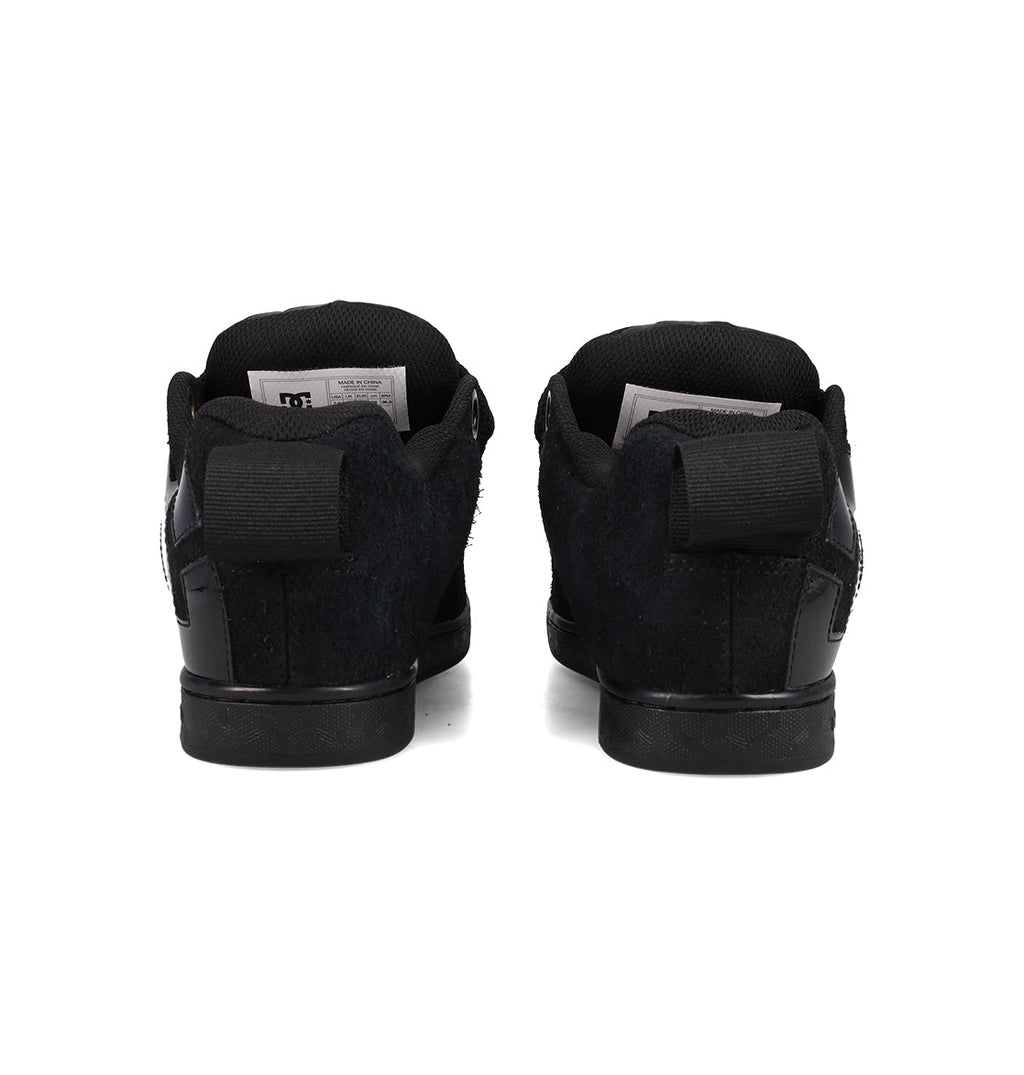 A pair of DC Shoes Women's Court Graffik Puff sneakers in black are shown from the back, side by side on a white background, with pull tabs and inner labels visible.