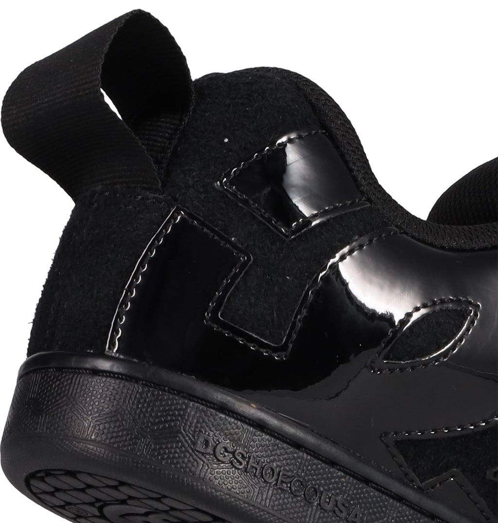 Close-up of the heel and side of DC Shoes Women's Court Graffik Puff Shoes in black, showcasing glossy and matte textures, stitched details, a fabric pull tab, and a textured rubber sole—bold statement sneakers from DC Shoes.
