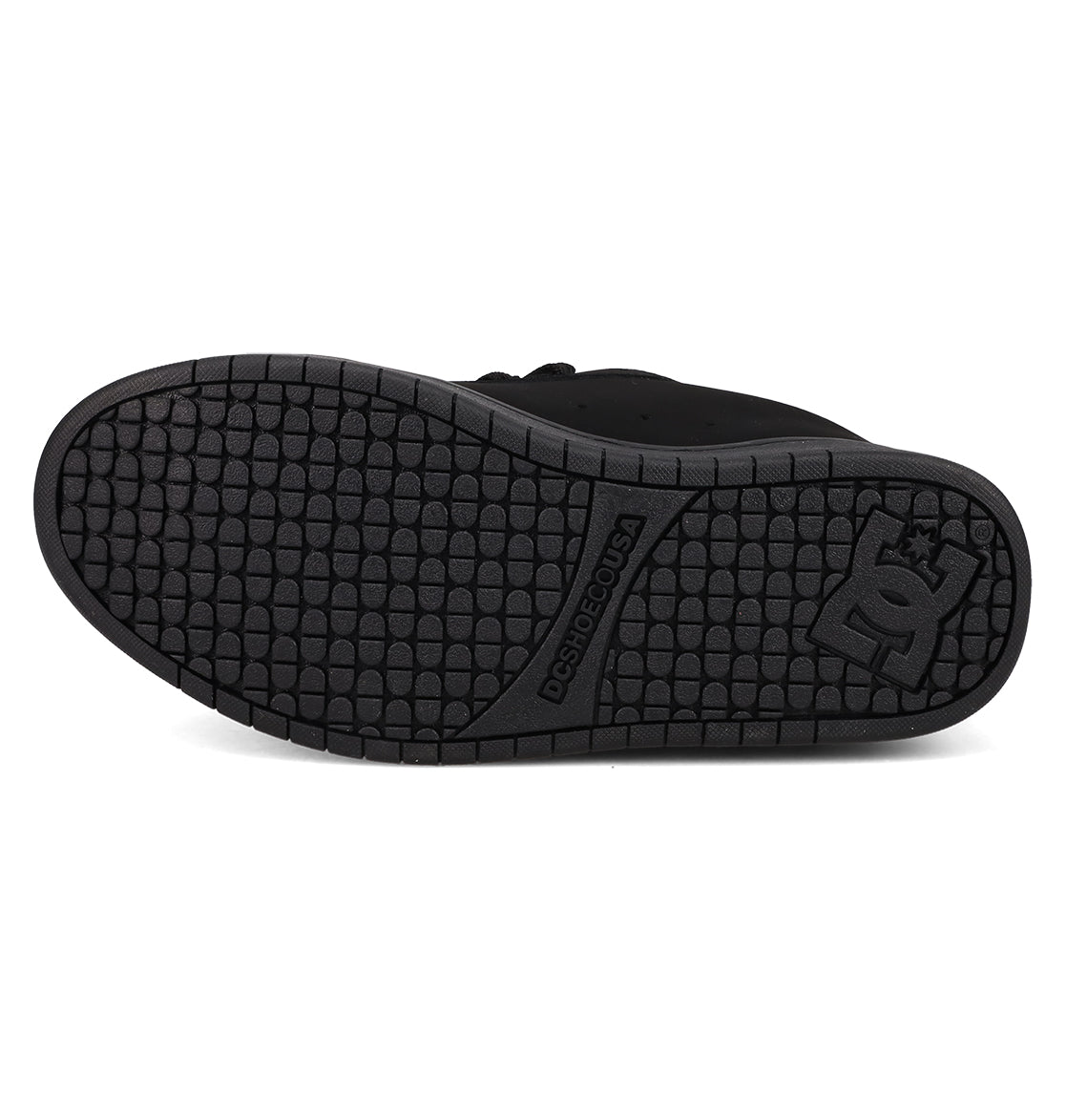 The image features the black rubber sole of the DC Shoes Men’s Court Graffik Day Of The Dead sneaker, displaying a textured tread pattern and the DC Shoes logo near the heel, from their vibrant Day of the Dead Collection inspired by Día de los Muertos.