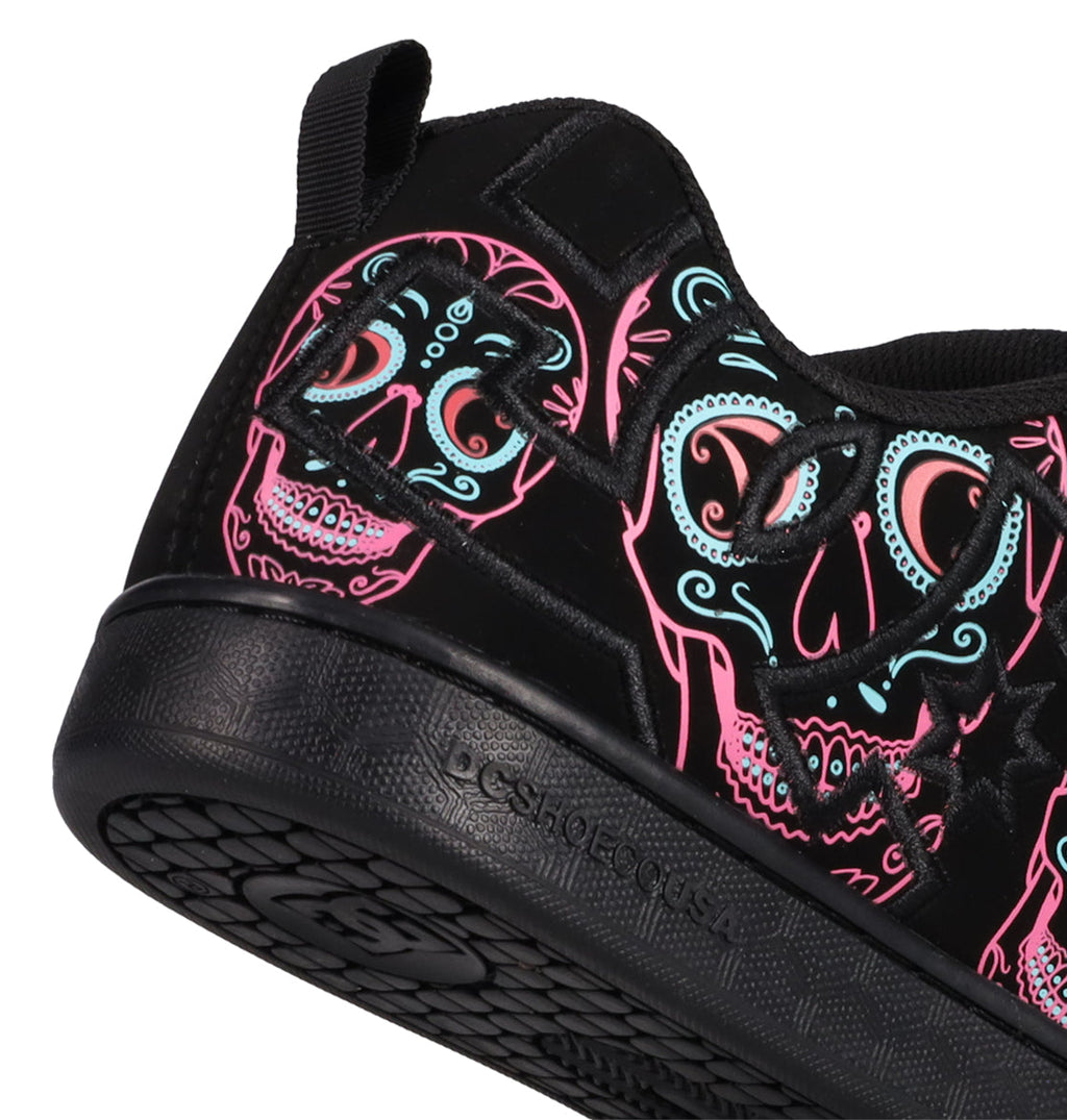 Step out in style with the Women’s Court Graffik Day Of The Dead by DC Shoes, featuring bold neon pink, blue, and white sugar skull artwork inspired by Día de los Muertos on a sleek black upper. Part of the Day of the Dead Collection, this sneaker boasts a textured sole for grip and a convenient black pull tab at the heel, blending DC Shoes comfort with festive flair.
