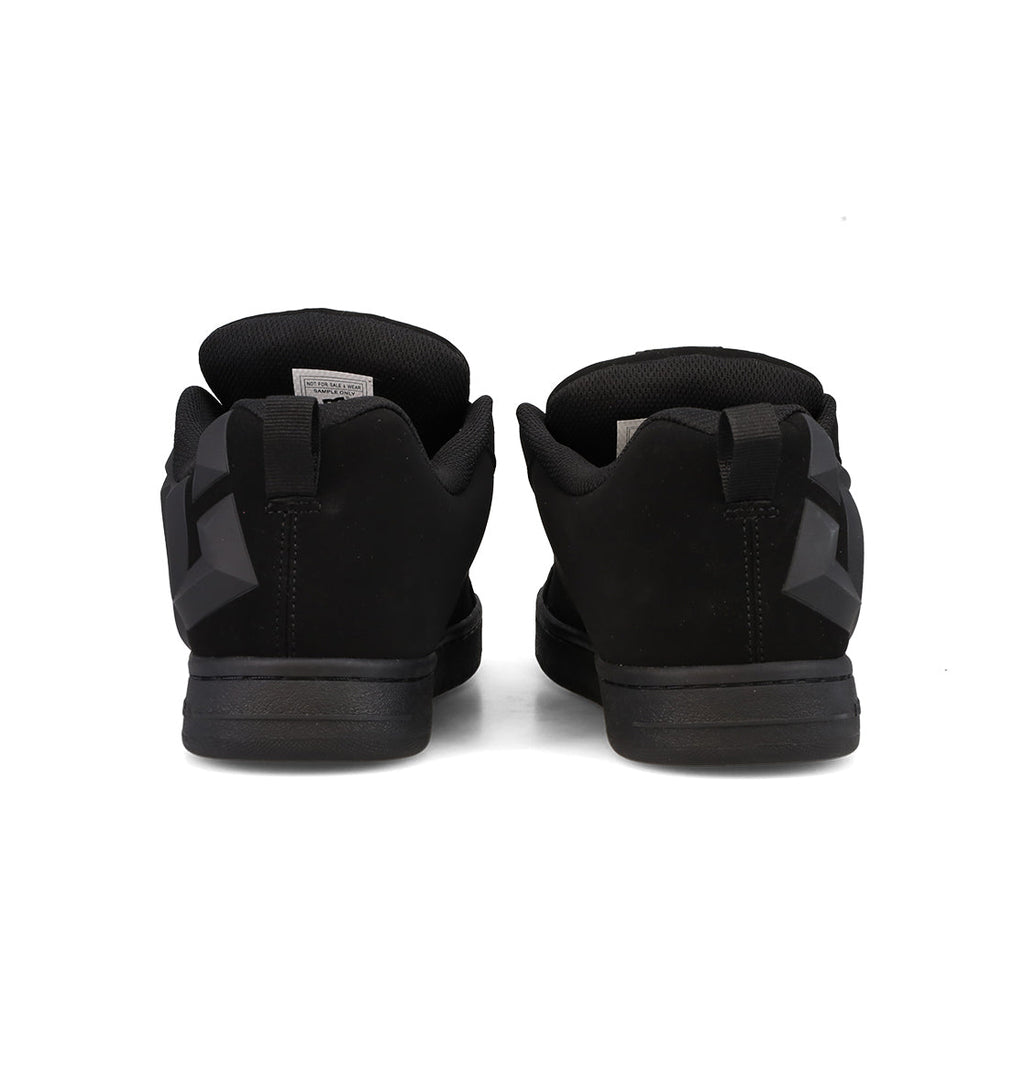 A pair of DC Shoes Men’s Court Graffik Beveled Shoes in black, viewed from the back to highlight the heels, heel tabs, and padded collars. The sneakers showcase a puffy silhouette with a matte finish, subtle geometric accents along the sides, and signature DC branding for an iconic streetwear style.