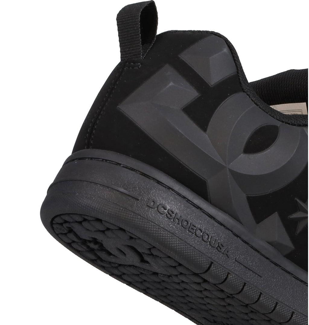 Close-up of the heel and side of a Men’s Court Graffik Beveled Shoe by DC Shoes, showcasing the signature puffy silhouette, bold embossed DC branding, and a textured rubber sole. This sneaker is part of the Court Graffik Beveled collection.