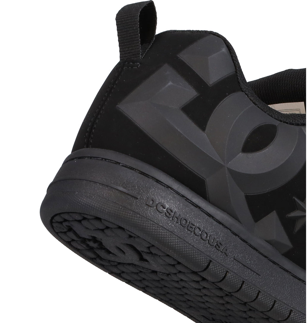 Close-up of the heel and side of a Men’s Court Graffik Beveled Shoe by DC Shoes, showcasing the signature puffy silhouette, bold embossed DC branding, and a textured rubber sole. This sneaker is part of the Court Graffik Beveled collection.