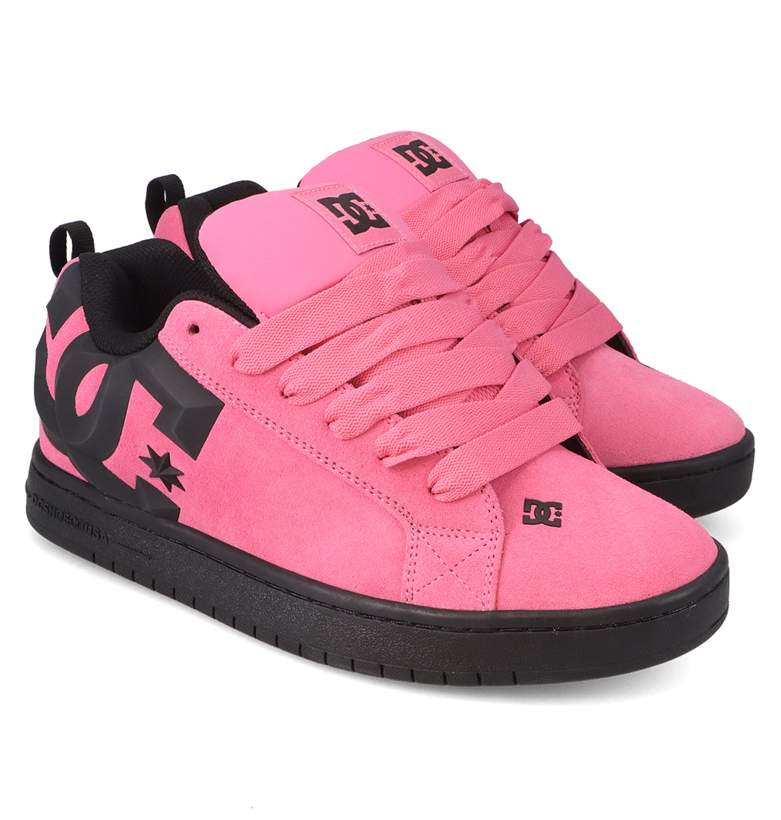 A pair of Men’s Court Graffik Beveled Special Edition Shoes by DC Shoes in vibrant pink, featuring bold black DC branding, thick laces, black soles, and black inner lining with the signature puffy silhouette, displayed side by side on a white background.