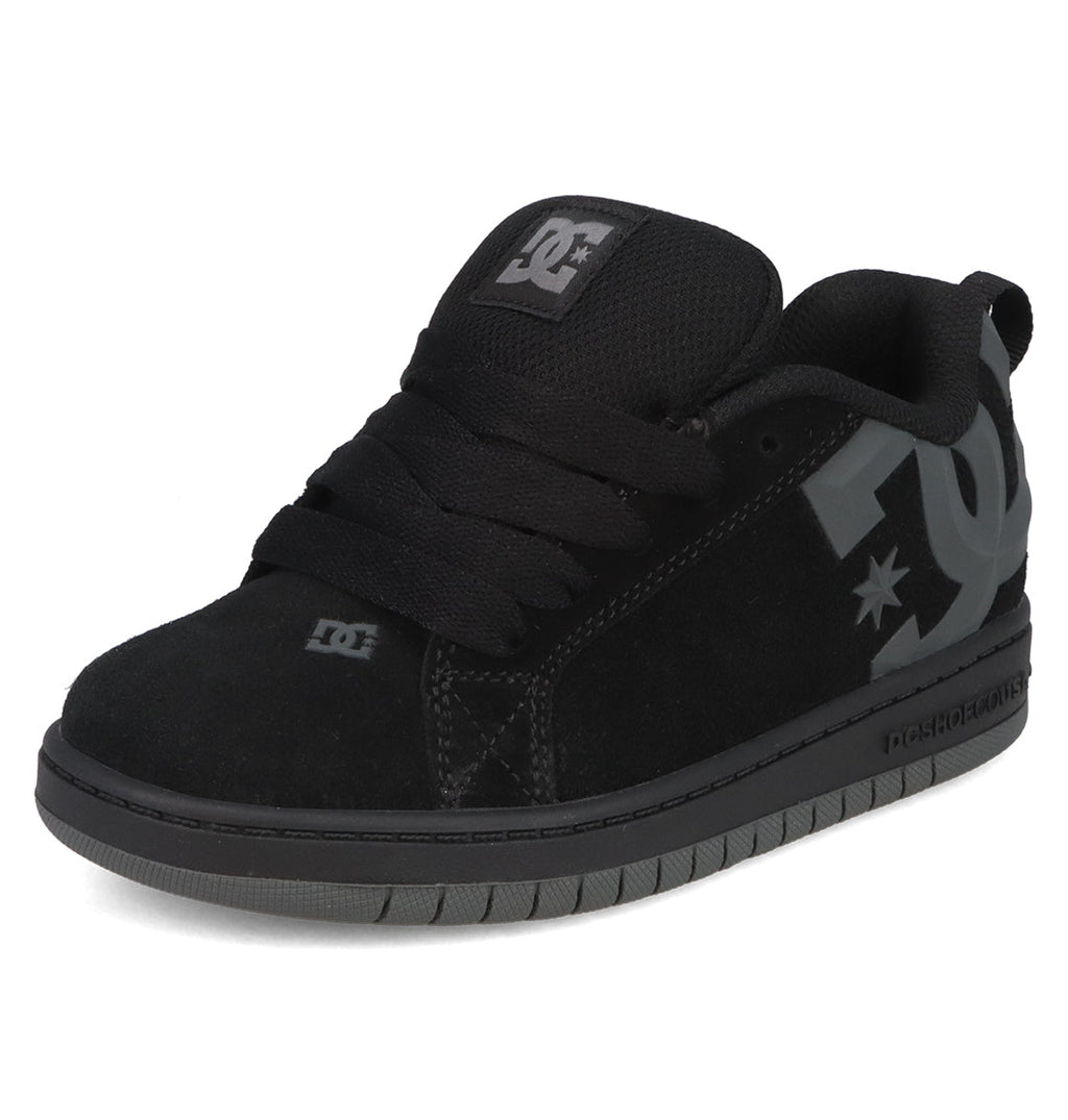 The Kids’ Court Graffik Beveled Special Edition Shoes by DC Shoes feature a black suede upper with a puffy silhouette, thick sole, black laces, and a beveled gray DC logo on the side. The shoes are photographed against a white background.