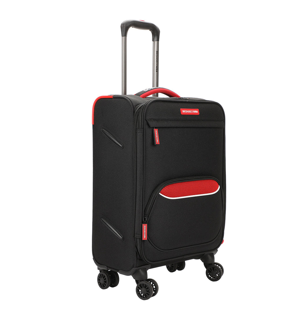 The DC Shoes DC Runner Carry-On is a black soft-shell suitcase with red accents, a front zippered pocket, four spinner wheels, and an extendable handle.