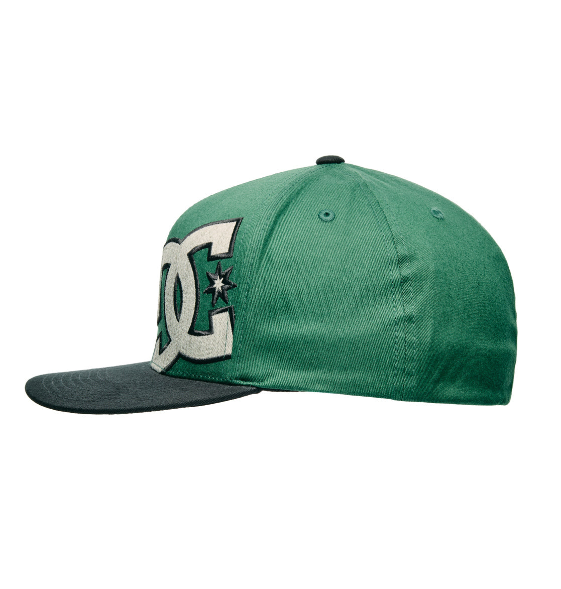 The Offset Flexfit cap by DC Shoes is shown from a side angle on a white background. It features a green crown, black flat brim, and a large white DC logo with a star on the front panel.