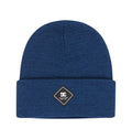 The Kids’ Label Beanie by DC Shoes is a blue knit beanie with a folded brim, featuring a black and white diamond-shaped patch on the front that displays the DC Shoes logo and the words “Quality Goods”—a perfect accessory for adding signature DC style to any outfit.