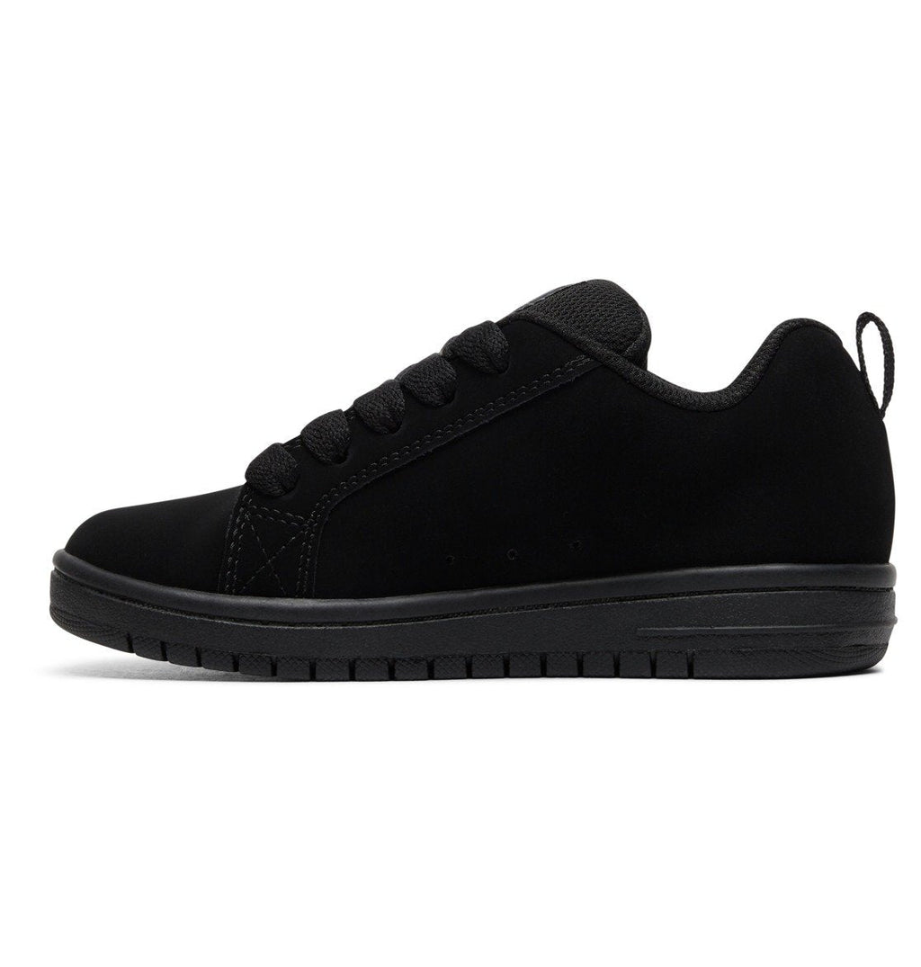The Kids’ Court Graffik Shoes by DC Shoes are black athletic sneakers with a low-profile design, rubber sole, black laces, and a heel pull tab. Featuring a subtly puffy silhouette inspired by the iconic Court Graffik style, the shoes are displayed in a side view against a white background.