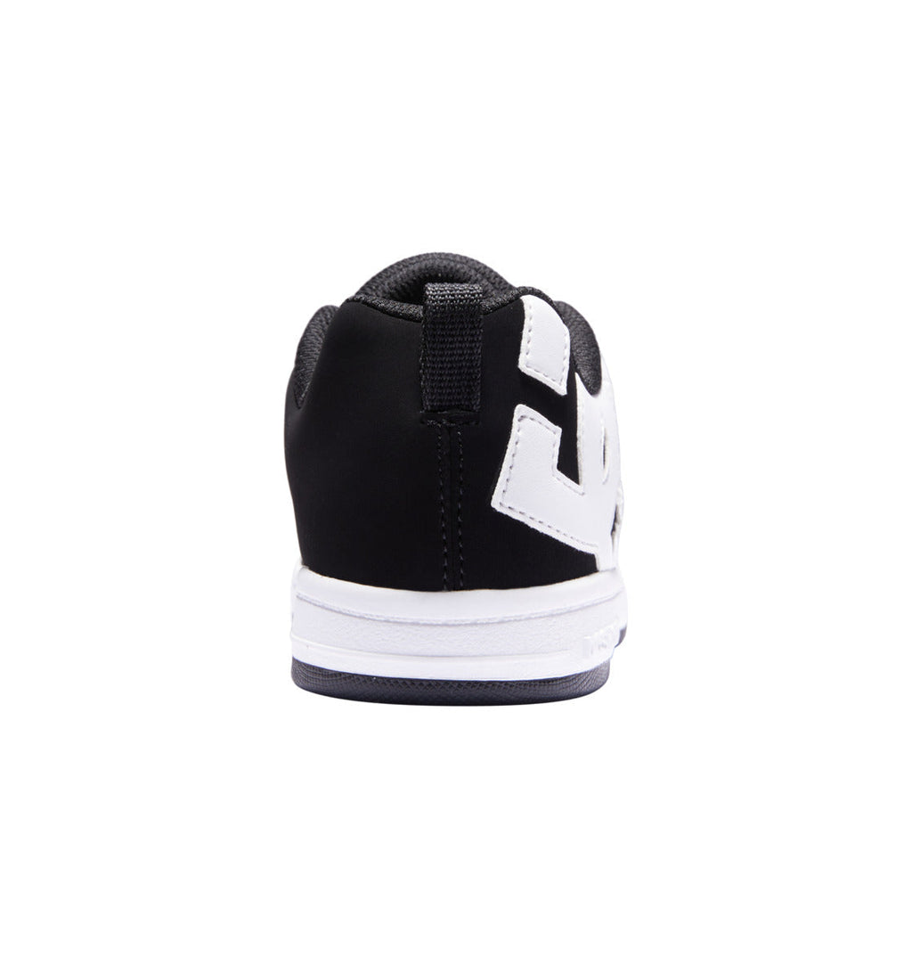 A black and white Kids’ Court Graffik Shoe from DC Shoes is seen from the back, highlighting its puffy silhouette, black heel, white sole, and striking white design along the side. Drawing inspiration from the iconic Court Graffik style, this sneaker stands out against a plain white background.
