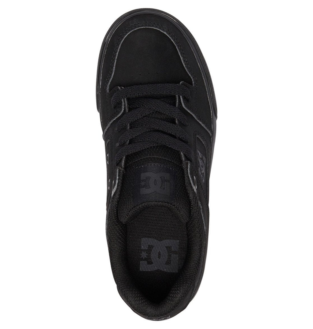 Top view of the Kids’ Pure Shoes by DC Shoes in black, featuring matching black laces and a prominent DC Shoes logo on both the tongue and insole, set against a white background—these durable sneakers deliver comfort and style, making them an excellent choice for kids’ skate shoes.