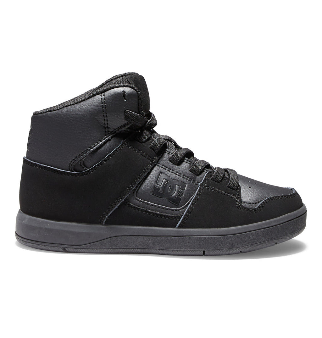 The DC Shoes Kids’ Cure High-Top Shoes feature an all-black design with matching black laces, a textured sole, and subtle logo accents on both the side and tongue. Photographed from the side against a white background, these affordable sneakers are a stylish choice for kids.