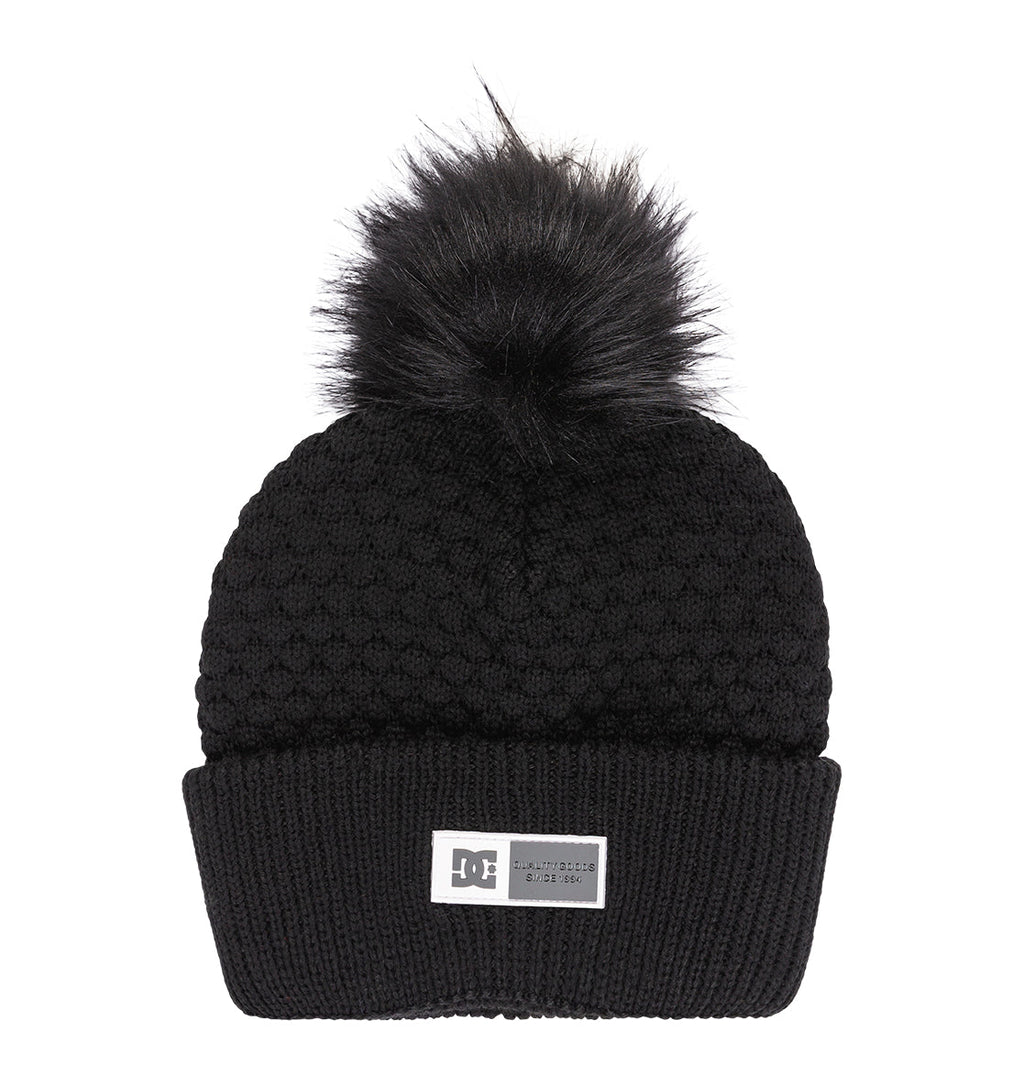 The Women’s Splendid Beanie by DC Shoes features a black knit, a textured pattern, wide folded brim, and a rectangular DC label on the front, finished with a large black faux fur pom-pom on top.