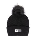 The Women’s Splendid Beanie by DC Shoes features a black knit, a textured pattern, wide folded brim, and a rectangular DC label on the front, finished with a large black faux fur pom-pom on top.