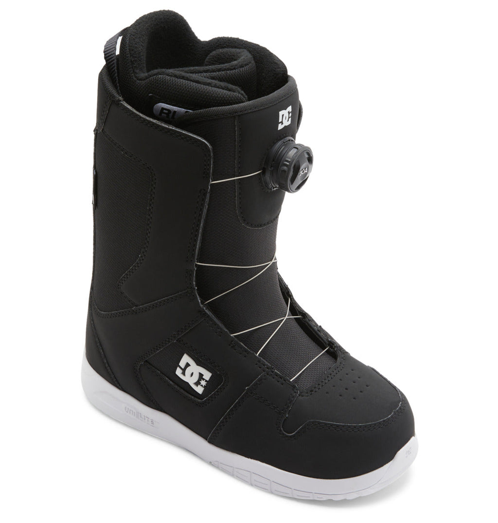 A black DC Shoes Women’s Phase BOA® Snowboard Boot with a white sole, featuring the advanced BOA® Fit System for precise lacing and the DC logo on the side. The boot is angled to display both the front and outer side.