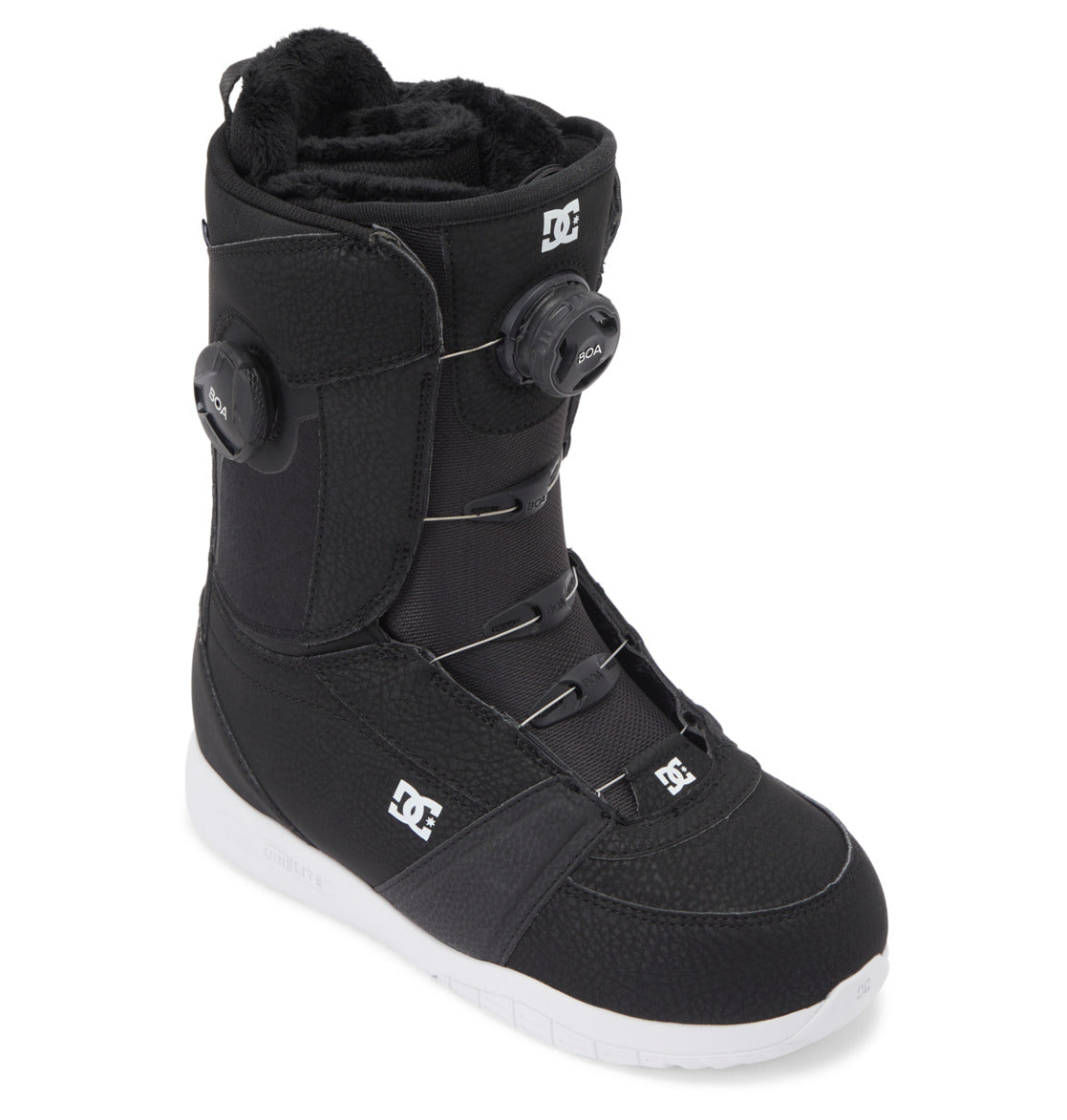 The DC Shoes Women's Lotus BOA® Snowboard Boots in black feature a white UNILITE outsole, Dual Zone BOA® Fit System for adjustable lacing, and a faux fur lining, shown at an angle on a white background.